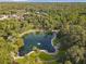 Aerial view featuring the community's pristine lake and lush landscaping at 136 Bridgeview Ct, Longwood, FL 32779