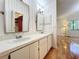 Bathroom featuring double vanity sinks, hardwood floors, updated fixtures, and natural lighting at 136 Bridgeview Ct, Longwood, FL 32779