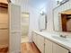 Spacious bathroom featuring double vanity sinks, hardwood floors, access to a closet, and plenty of storage at 136 Bridgeview Ct, Longwood, FL 32779