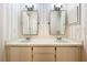 Bathroom featuring double vanity sinks with updated fixtures and sconces, and neutral decor at 136 Bridgeview Ct, Longwood, FL 32779