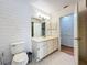 Bathroom with a white vanity, large mirror, tiled floors, and a shower with glass doors at 136 Bridgeview Ct, Longwood, FL 32779
