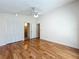 Bedroom boasts hardwood floors, closet space, ceiling fan, and access to an adjacent bathroom at 136 Bridgeview Ct, Longwood, FL 32779