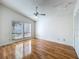 Bedroom with hardwood floors, a ceiling fan, and a large window with natural light at 136 Bridgeview Ct, Longwood, FL 32779