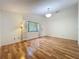 Inviting bedroom with hardwood floors, a large window, and neutral decor for a peaceful ambiance at 136 Bridgeview Ct, Longwood, FL 32779