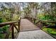Wooden bridge in the community with lush greenery and trees at 136 Bridgeview Ct, Longwood, FL 32779