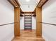 Walk-in closet featuring built-in shelves and rod systems, maximizing storage and organization at 136 Bridgeview Ct, Longwood, FL 32779