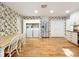 Bright kitchen and dining area with stainless steel appliances, a laundry area, and hardwood floors at 136 Bridgeview Ct, Longwood, FL 32779