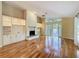 Bright living room featuring a stone fireplace, hardwood floors, and large windows offering natural light at 136 Bridgeview Ct, Longwood, FL 32779