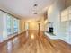 Bright living room featuring hardwood floors and a striking stone fireplace at 136 Bridgeview Ct, Longwood, FL 32779
