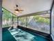 Enclosed screened porch with a ceiling fan, offering a view of the backyard at 136 Bridgeview Ct, Longwood, FL 32779