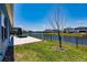 Beautiful backyard with lake view, new construction homes, manicured lawn and brick patio at 13828 Tybee Beach Ln, Orlando, FL 32827