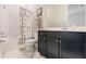 Bathroom features white marble floors, a shower with a tub, and a vanity with dark cabinets at 13828 Tybee Beach Ln, Orlando, FL 32827