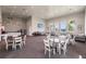 Spacious clubhouse featuring a social area with kitchenette, tables, and comfortable lounge seating at 13828 Tybee Beach Ln, Orlando, FL 32827