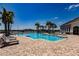 Community pool featuring lounge chairs, palm trees, and inviting clear blue water for relaxation and recreation at 13828 Tybee Beach Ln, Orlando, FL 32827