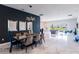 Elegant dining area boasting contemporary lighting, designer mirrors, and an open-concept layout at 13828 Tybee Beach Ln, Orlando, FL 32827