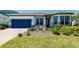 Charming single-story home featuring a well-manicured lawn, beautiful landscaping, and a two-car garage at 13828 Tybee Beach Ln, Orlando, FL 32827