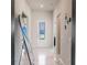 Well-lit hallway featuring marble floors, neutral paint, and a decorative mirror at 13828 Tybee Beach Ln, Orlando, FL 32827