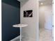 A hallway features a table with two small coffee cups and a dark wall at 13828 Tybee Beach Ln, Orlando, FL 32827