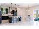 Open kitchen boasts a large island with pendant lighting, modern appliances, and an adjacent dining area at 13828 Tybee Beach Ln, Orlando, FL 32827