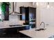 Well-equipped kitchen features gas cooktop, stainless steel appliances, quartz countertops, and modern backsplash at 13828 Tybee Beach Ln, Orlando, FL 32827