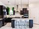Modern kitchen features a large island with seating, stainless steel appliances, and pendant lighting at 13828 Tybee Beach Ln, Orlando, FL 32827