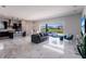 Spacious open-concept living area with stylish marble floors, modern décor, and access to outdoor space at 13828 Tybee Beach Ln, Orlando, FL 32827