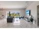 Bright and airy living space featuring marble floors, contemporary furnishings, and scenic backyard views at 13828 Tybee Beach Ln, Orlando, FL 32827