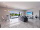 Open-concept living room boasting marble floors, modern lighting, and sliding glass doors with a water view at 13828 Tybee Beach Ln, Orlando, FL 32827