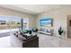 Bright living room features sliding glass doors leading to outdoor space with modern furniture and water views at 13828 Tybee Beach Ln, Orlando, FL 32827