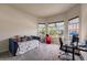 Bright office with multiple windows, comfortable seating, and a functional desk setup at 13828 Tybee Beach Ln, Orlando, FL 32827