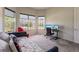 Bright office with multiple windows, comfortable seating, and a functional desk setup for productivity at 13828 Tybee Beach Ln, Orlando, FL 32827