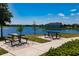 Charming picnic area with tables overlooking a serene lake, offering a peaceful outdoor experience at 13828 Tybee Beach Ln, Orlando, FL 32827