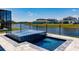 Backyard pool showcasing intricate tile details and community lake view at 13828 Tybee Beach Ln, Orlando, FL 32827