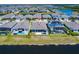 Stunning rear view of the home highlighting its patio, lake access, and seamless integration with the natural surroundings at 13828 Tybee Beach Ln, Orlando, FL 32827
