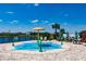 Fun splash pad with colorful features, surrounded by seating and a lake, perfect for Gathering fun and relaxation at 13828 Tybee Beach Ln, Orlando, FL 32827