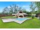 Large inground pool is framed by a spacious concrete patio and a lush lawn at 14143 Conifer Dr, Orlando, FL 32832