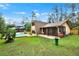 This home has a spacious backyard with a screen porch and in-ground pool at 14143 Conifer Dr, Orlando, FL 32832