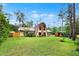 Expansive backyard featuring lush landscaping and a charming exterior at 14143 Conifer Dr, Orlando, FL 32832