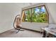 Enclosed balcony featuring a hanging egg chair and a tranquil view of the surrounding trees at 14143 Conifer Dr, Orlando, FL 32832