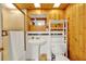 Rustic bathroom with wood paneling, white fixtures, and ample natural light at 14143 Conifer Dr, Orlando, FL 32832