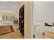 Bedroom leading to bathroom, TV and balcony at 14143 Conifer Dr, Orlando, FL 32832