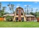 Charming A-frame home with a well-maintained lawn, mature trees, and inviting curb appeal at 14143 Conifer Dr, Orlando, FL 32832