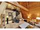 Spacious living room showcasing a spiral staircase, unique stone tile, and a high, vaulted wooden ceiling at 14143 Conifer Dr, Orlando, FL 32832