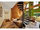 Living room with spiral staircase, high ceilings and wooden accents at 14143 Conifer Dr, Orlando, FL 32832
