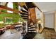 Bright living room featuring vaulted wood ceilings, unique spiral staircase, and natural light at 14143 Conifer Dr, Orlando, FL 32832