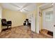Comfortable home office with tile flooring, a ceiling fan, a built-in desk, and natural light from the door at 14143 Conifer Dr, Orlando, FL 32832
