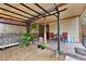 Charming backyard patio area featuring outdoor seating, decorative plants, and a covered pergola at 14143 Conifer Dr, Orlando, FL 32832
