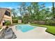 Inviting backyard pool and patio with mature trees and a storage building at 14143 Conifer Dr, Orlando, FL 32832