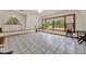 Bright sitting area with tile flooring, large windows overlooking the pool, and a cozy seating arrangement at 14143 Conifer Dr, Orlando, FL 32832