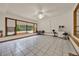 Sitting area showcasing tile flooring, large windows with pool views, and a ceiling fan for added comfort at 14143 Conifer Dr, Orlando, FL 32832